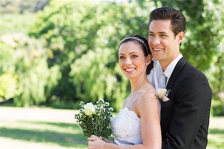 simsearch:400-07473234,k - Happy loving newly wed couple looking away while standing in park Stock Photo - Budget Royalty-Free & Subscription, Code: 400-07468518