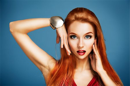 Beauty Portrait of Sexy Red Haired Woman Touching Her Face on Blue Backgound. Long Hair. Holiday Makeup. Smoky Eyes and Red Lipstick. Glamour Woman. Fotografie stock - Microstock e Abbonamento, Codice: 400-07461507