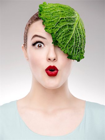 Portrait of a woman illustrating a vegan concept with a cabbage on the head Stock Photo - Budget Royalty-Free & Subscription, Code: 400-07462884