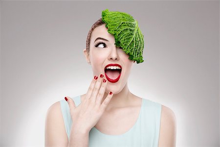 Portrait of a woman illustrating a vegan concept with a cabbage on the head Stock Photo - Budget Royalty-Free & Subscription, Code: 400-07462885