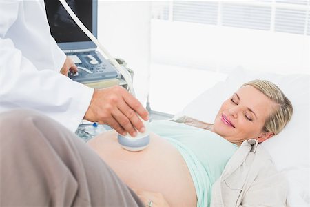 simsearch:6109-08203392,k - Smiling pregnant woman having a sonagram scan at the hospital Stock Photo - Budget Royalty-Free & Subscription, Code: 400-07474029