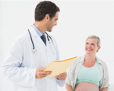 doctor speak with pregnant - Happy pregnant woman having a check up with doctor at the hospital Stock Photo - Budget Royalty-Free & Subscription, Code: 400-07474047
