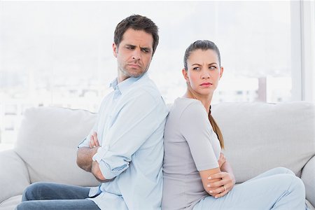 simsearch:877-07460598,k - Angry couple sitting back to back on the couch at home in the living room Stock Photo - Budget Royalty-Free & Subscription, Code: 400-07474198