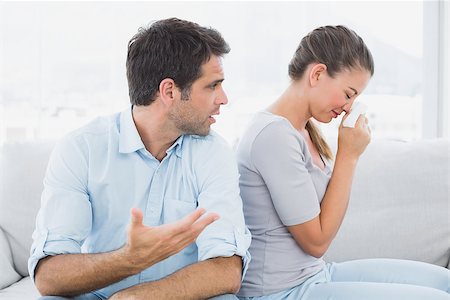 Man pleading with his crying partner on the couch at home in the living room Stock Photo - Budget Royalty-Free & Subscription, Code: 400-07474200