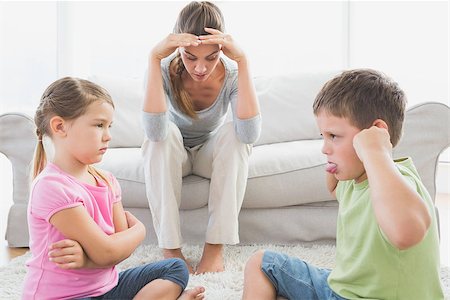 Fed up mother listening to her young children fight at home in the living room Stock Photo - Budget Royalty-Free & Subscription, Code: 400-07474343