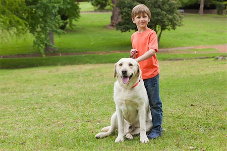 Full length portrait of a boy with pet dog at the park Stock Photo - Budget Royalty-Free & Subscription, Code: 400-07474860