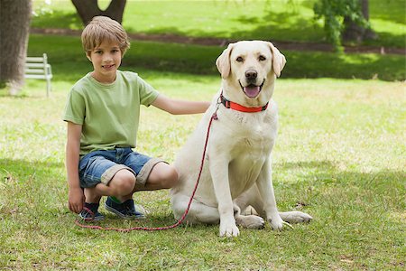 Full length portrait of a young boy with pet dog at the park Stock Photo - Budget Royalty-Free & Subscription, Code: 400-07474873