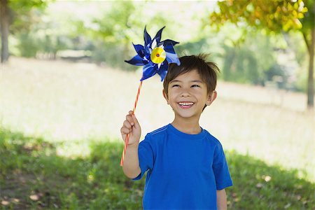 Portrait of a happy cute little boy holding pinwheel at the park Stock Photo - Budget Royalty-Free & Subscription, Code: 400-07475334