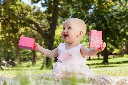 Cute happy baby sitting on blanket with a box at the park Stock Photo - Budget Royalty-Free & Subscription, Code: 400-07475434
