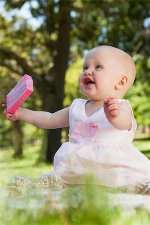 Cute happy baby sitting on blanket with a box at the park Stock Photo - Budget Royalty-Free & Subscription, Code: 400-07475435
