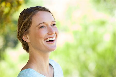 Close-up of a cheerful thoughtful young woman looking away in the park Stock Photo - Budget Royalty-Free & Subscription, Code: 400-07475449