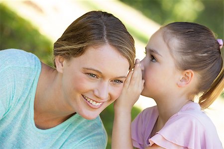 Close-up of a little young girl whispering secret into mother's ear at the park Stock Photo - Budget Royalty-Free & Subscription, Code: 400-07475453