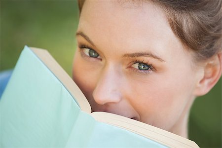 Extreme close-up portrait of a beautiful young woman with book in the park Stock Photo - Budget Royalty-Free & Subscription, Code: 400-07475540