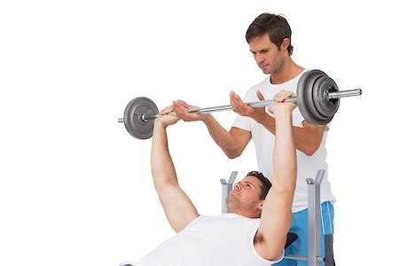 simsearch:400-07333355,k - Male trainer helping young fit man to lift the barbell bench press over white background Stock Photo - Budget Royalty-Free & Subscription, Code: 400-07475561