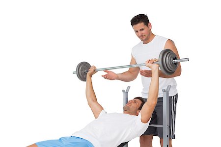 simsearch:400-07333355,k - Male trainer helping young fit man to lift the barbell bench press over white background Stock Photo - Budget Royalty-Free & Subscription, Code: 400-07475563