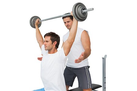 simsearch:400-07333355,k - Male trainer helping young fit man to lift the barbell bench press over white background Stock Photo - Budget Royalty-Free & Subscription, Code: 400-07475572