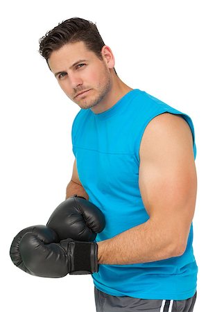 simsearch:400-06876600,k - Portrait of a serious male boxer standing over white background Stock Photo - Budget Royalty-Free & Subscription, Code: 400-07475591