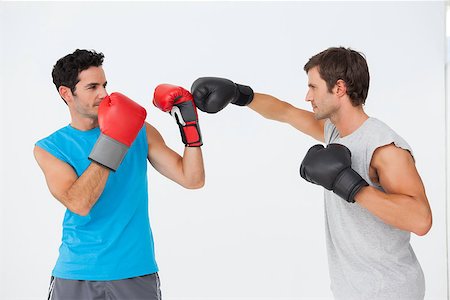 simsearch:400-07143098,k - Side view of two male boxers practicing over white background Stock Photo - Budget Royalty-Free & Subscription, Code: 400-07475727