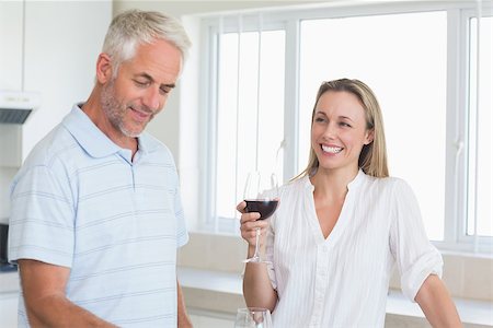 simsearch:6109-08394929,k - Happy couple standing at home in the kitchen Stockbilder - Microstock & Abonnement, Bildnummer: 400-07475809