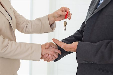 simsearch:400-07475963,k - Estate agent giving house key to customer in empty house Stock Photo - Budget Royalty-Free & Subscription, Code: 400-07475939