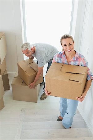 simsearch:400-07928013,k - Happy couple carrying cardboard moving boxes in their new home Fotografie stock - Microstock e Abbonamento, Codice: 400-07475979