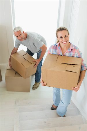 simsearch:400-07928013,k - Happy couple carrying cardboard moving boxes in their new home Fotografie stock - Microstock e Abbonamento, Codice: 400-07475980