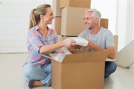 simsearch:400-07928013,k - Happy couple unpacking cardboard moving boxes in their new home Fotografie stock - Microstock e Abbonamento, Codice: 400-07475990