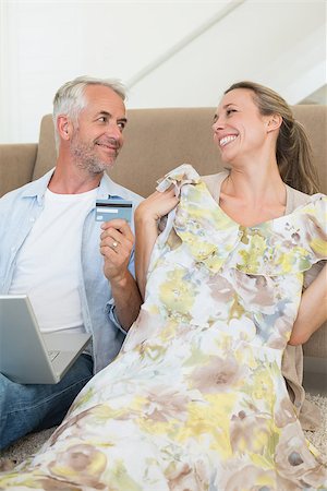 simsearch:400-07474252,k - Happy couple shopping online on the couch at home in the living room Stock Photo - Budget Royalty-Free & Subscription, Code: 400-07476066