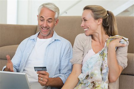 simsearch:400-07474252,k - Happy couple shopping online on the couch at home in the living room Stock Photo - Budget Royalty-Free & Subscription, Code: 400-07476070