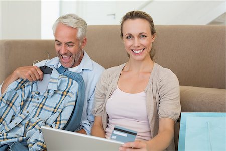 simsearch:400-07474252,k - Happy couple shopping online on the couch at home in the living room Stock Photo - Budget Royalty-Free & Subscription, Code: 400-07476071