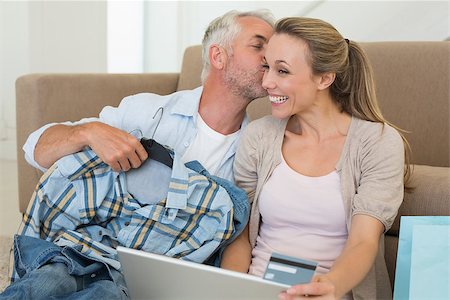 simsearch:400-07474252,k - Happy couple shopping online on the couch at home in the living room Stock Photo - Budget Royalty-Free & Subscription, Code: 400-07476072