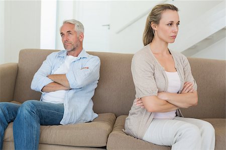simsearch:877-07460598,k - Angry couple sitting on couch not talking to each other at home in the living room Stock Photo - Budget Royalty-Free & Subscription, Code: 400-07476095