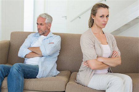 simsearch:877-07460598,k - Angry couple sitting on couch not talking to each other at home in the living room Stock Photo - Budget Royalty-Free & Subscription, Code: 400-07476096
