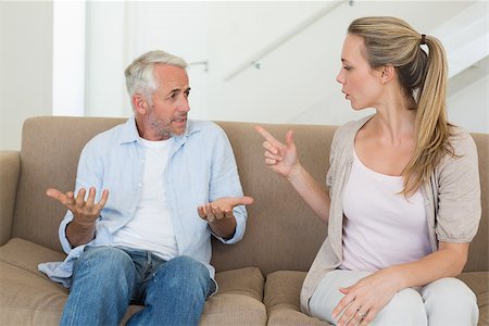 simsearch:877-07460598,k - Angry couple sitting on couch arguing at home in the living room Stock Photo - Budget Royalty-Free & Subscription, Code: 400-07476098