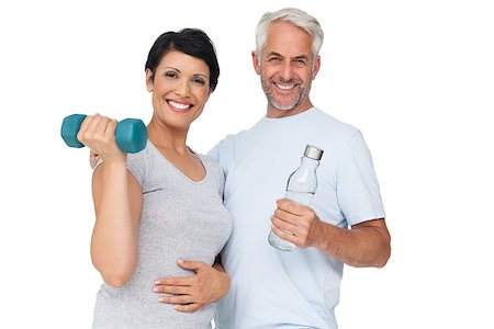 fitness   mature woman - Portrait of a happy fit couple with dumbbell and water bottle white background Stock Photo - Budget Royalty-Free & Subscription, Code: 400-07476249