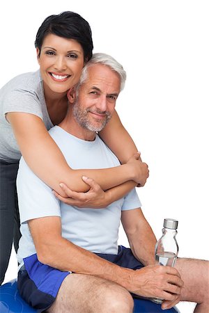 exercise for women over 50 years old - Portrait of a happy woman embracing man from behind over white background Stock Photo - Budget Royalty-Free & Subscription, Code: 400-07476251