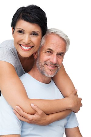 exercise for women over 50 years old - Portrait of a happy woman embracing man from behind over white background Stock Photo - Budget Royalty-Free & Subscription, Code: 400-07476252