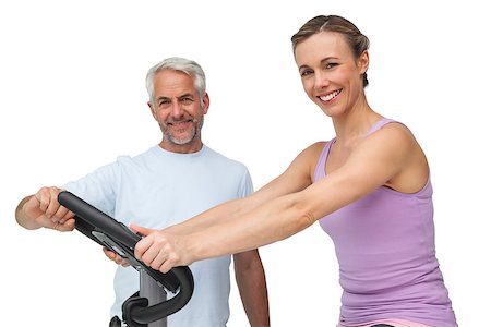 exercise for women over 50 years old - Portrait of a happy woman on stationary bike with trainer over white background Stock Photo - Budget Royalty-Free & Subscription, Code: 400-07476261