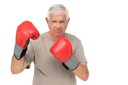 simsearch:400-07143098,k - Portrait of a determined senior boxer standing over white background Stock Photo - Budget Royalty-Free & Subscription, Code: 400-07476279