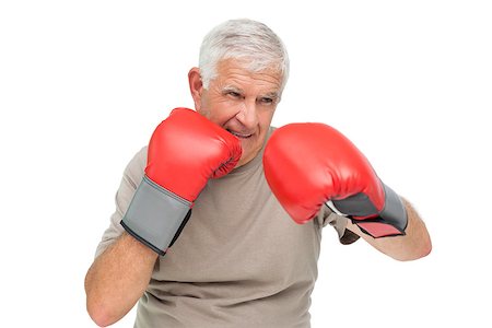 simsearch:693-07455847,k - Close-up portrait of a determined senior boxer over white background Stockbilder - Microstock & Abonnement, Bildnummer: 400-07476281