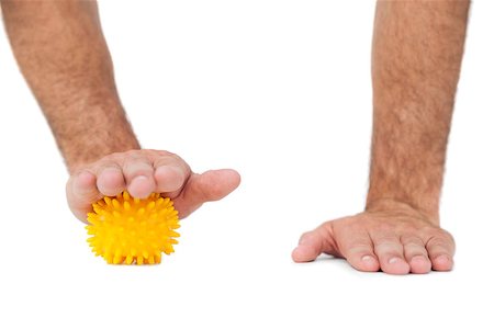 prickly object - Close-up of hand over stress ball against white  background Stock Photo - Budget Royalty-Free & Subscription, Code: 400-07476324