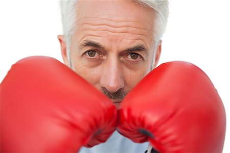 simsearch:400-07143098,k - Close-up portrait of a determined senior boxer over white backgroundClose-up portrait of a determined senior boxer over white background Stock Photo - Budget Royalty-Free & Subscription, Code: 400-07476352