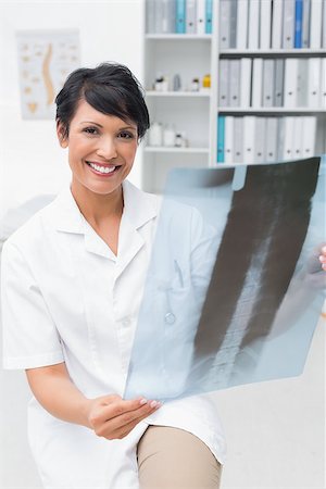 simsearch:400-07778150,k - Portrait of a smiling female doctor examining x-ray in the medical office Stock Photo - Budget Royalty-Free & Subscription, Code: 400-07476466