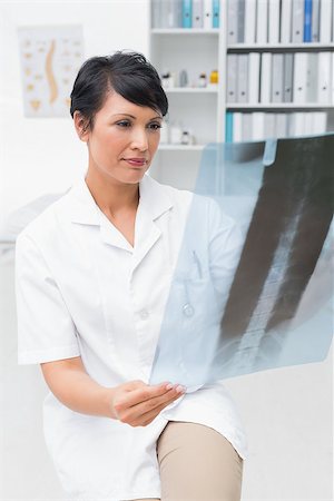 simsearch:400-07778150,k - Concentrated female doctor examining x-ray in the medical office Stock Photo - Budget Royalty-Free & Subscription, Code: 400-07476467