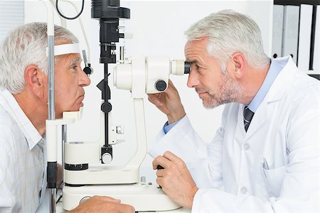 eye doctor (male) - Side view of an optometrist doing sight testing for senior patient Stock Photo - Budget Royalty-Free & Subscription, Code: 400-07476616