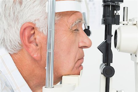 eye doctor (male) - Close-up side view of a senior man getting his cornea checked Stock Photo - Budget Royalty-Free & Subscription, Code: 400-07476611