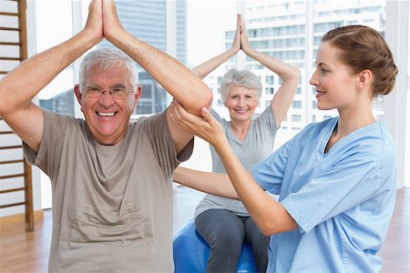 Female therapist assisting senior couple with exercises in the medical office Stock Photo - Budget Royalty-Free & Subscription, Code: 400-07476645