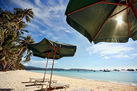 Sun umbrella with chair longues on tropical beach, Philippines, Boracay Stock Photo - Budget Royalty-Free & Subscription, Code: 400-07477409