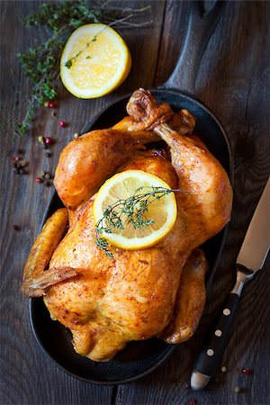 simsearch:400-07826555,k - Whole roasted chicken with lemon and thyme on a pan. Rustic style. Fotografie stock - Microstock e Abbonamento, Codice: 400-07477629