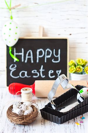 Easter cooking. Bunny cookie cutter, rolling pin and colorful chocolate eggs. Stock Photo - Budget Royalty-Free & Subscription, Code: 400-07477647
